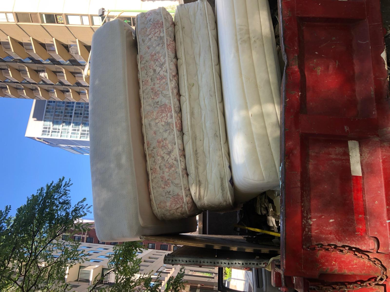 Truck loaded with mattresses for removal
