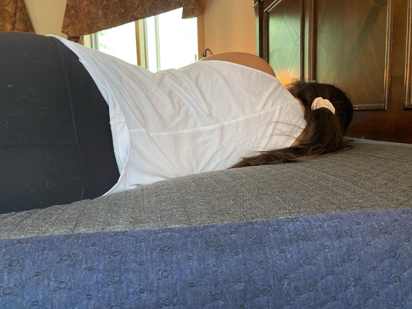 Testing mattress firmness by lying on it in different positions